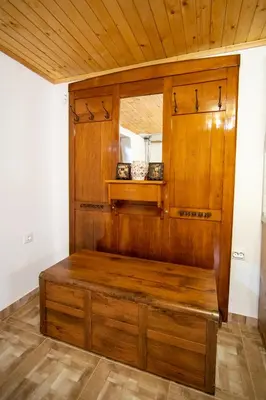 a wooden bench in a room with a wooden ceiling at Къща за гости детелина - лина in Sapareva Banya