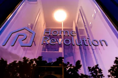 a window with a home revolution sign on it at HomeRevolution in Marikostinovo