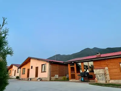 a group of buildings with mountains in the background at Къщи за гости “Планински Рай” Mountain Paradise in Resilovo