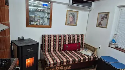 a room with a couch in a kitchen with a window at Modern and Old LODGE in Sofia