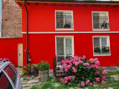 a red house with flowers in front of it at Modern and Old LODGE in Sofia