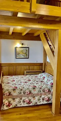 a bedroom with a bed in a wooden room at Pirin Golf Hotel Private Apartments Апартаменти Планински Изгрев в Пирин Голф in Razlog