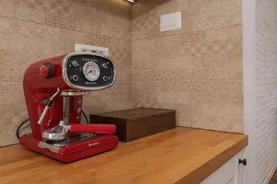 a red sewing machine sitting on top of a wooden counter at 2BD Flamingo Flat with Balcony in Sofia Center by Flat Mаnager in Sofia