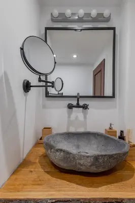 a bathroom with a large stone sink and a mirror at 2BD Flamingo Flat with Balcony in Sofia Center by Flat Mаnager in Sofia