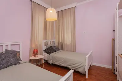 a small bedroom with two beds and a lamp at 2BD Flamingo Flat with Balcony in Sofia Center by Flat Mаnager in Sofia