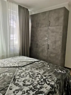 a bedroom with a bed and a dresser at Sofia hotel apartments in Sofia