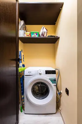 a washing machine in a small room with a shelf at Cozy new Apartment 'Casa Vacanza ' ✵ TOP CENTER ✵ in Plovdiv