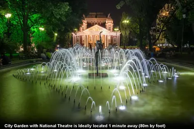 a water fountain in front of a building at night at Top Center Detached Apartment Studio in Sofia