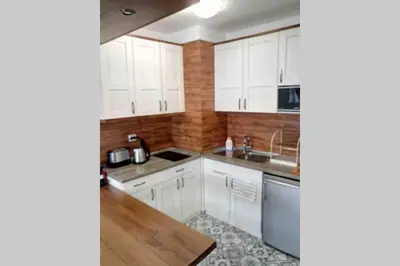 a kitchen with white cabinets and a sink at Belvedere Holiday Club VIP Apartment H 82 in Bansko