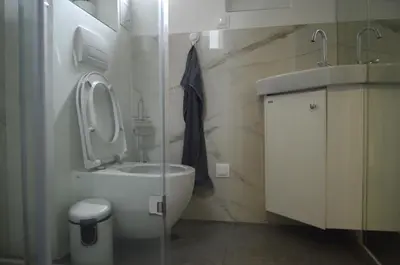a bathroom with a toilet and a sink at Brand New Apartment in Sofia
