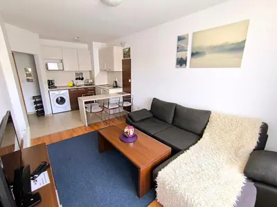a living room with a couch and a table at Belvedere Holiday Club Private Apartment in Bansko