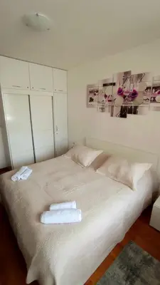 a bedroom with a bed with two towels on it at Belvedere Holiday Club Private Apartment in Bansko