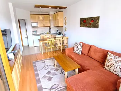 a living room with a couch and a table at Belvedere Holiday Club Private Apartment in Bansko