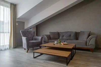 a living room with a couch and two chairs and a table at Luxury 2-bedroom apartment by Studenets Center by Flat Mаnager in Pamporovo