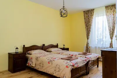 a bedroom with two beds and a window at Къща Лиляна in Resilovo