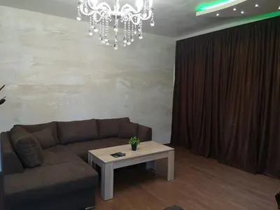a living room with a couch and a table at Вила Мая 2 in Krayni Dol