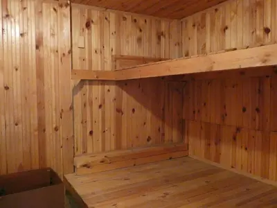 an empty sauna with wooden walls and wooden shelves at Grande - Velingrad in Velingrad