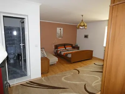 a bedroom with a bed and a bathroom at Grande - Velingrad in Velingrad