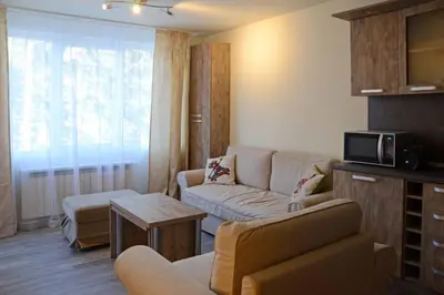 a living room with a couch and a table at Cozy One Bedroom Apartment in Iglika Complex in Borovets
