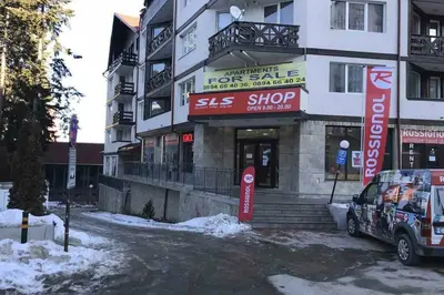 a building with a sign for a shop in front of it at Cozy One Bedroom Apartment in Iglika Complex in Borovets