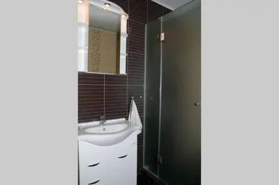 a bathroom with a sink and a mirror at Cozy One Bedroom Apartment in Iglika Complex in Borovets