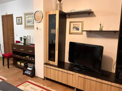 a living room with a flat screen tv on a entertainment center at Апартамент Планинско Гнездо - Mountain Nest in Stoykite