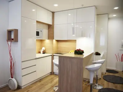 a kitchen with white cabinets and a counter at Borovets Gardens Luxury apartment E11 in Borovets