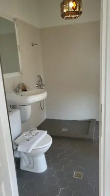a bathroom with a white toilet and a sink at Villa al Tempio in Pazardzhik