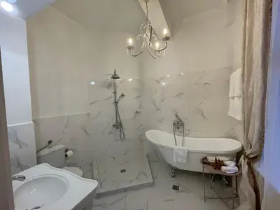 a bathroom with a sink and a tub and a toilet at Villa al Tempio in Pazardzhik