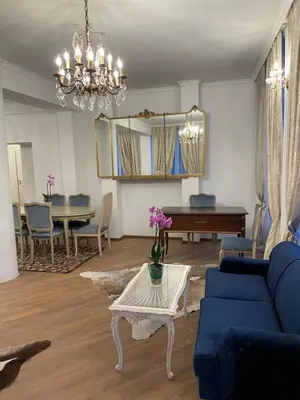 a living room with a blue couch and a table at Villa al Tempio in Pazardzhik