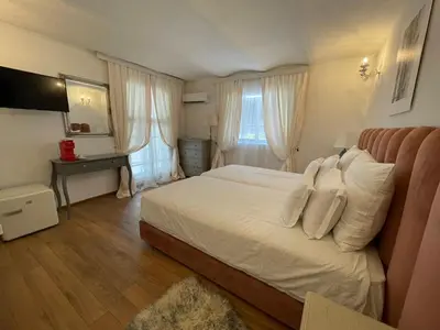 a bedroom with a large bed with white pillows at Villa al Tempio in Pazardzhik