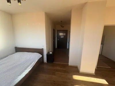 an empty room with a bed and a hallway at Bansko Royal Towers - Studio 153 in Bansko