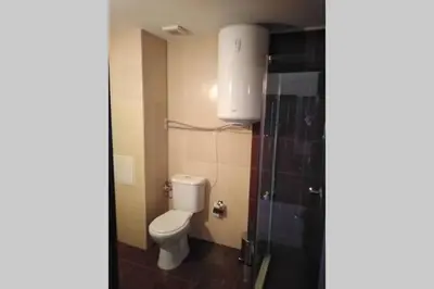 a small bathroom with a toilet and a sink at Bansko Royal Towers - Studio 153 in Bansko