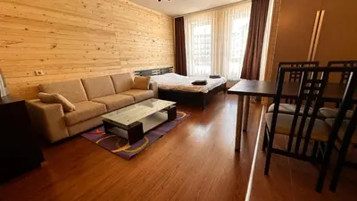 a living room with a couch and a table at Bansko Royal Towers - Studio 1237 in Bansko