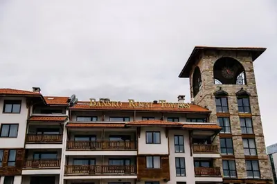a building with a clock tower on top of it at Bansko Royal Towers - Studio 1237 in Bansko