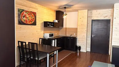 a kitchen with a table and a pizza on the wall at Bansko Royal Towers - Studio 1237 in Bansko