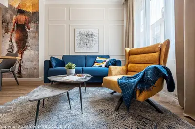 a living room with a blue couch and a chair at Top Center 2 Aptartments - Gurko Str in Sofia