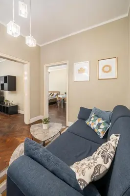 a living room with a blue couch and a table at Top Center 2 Aptartments - Gurko Str in Sofia