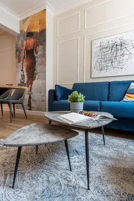 a living room with a blue couch and a table at Top Center 2 Aptartments - Gurko Str in Sofia