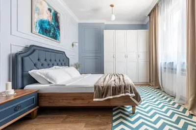 a bedroom with a bed with a blue headboard at Top Center 2 Aptartments - Gurko Str in Sofia