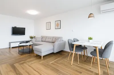 a living room with a couch and a table at South Panoramic Apartment in the art district of Kapana in Plovdiv
