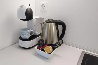 a coffeemaker with a coffee maker and a tea kettle at South Panoramic Apartment in the art district of Kapana in Plovdiv