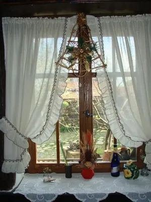 a window with white curtains and a table in front of it at Старата къща / село Тъжа in Tŭzha