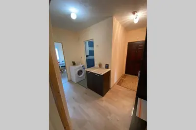 a bathroom with a sink and a washing machine at Sunny apartment by the river in Sandanski