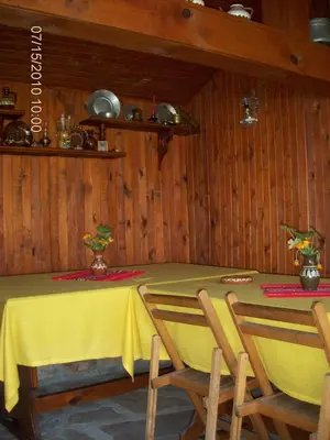 a dining room with a yellow table and chairs at Янко Кехая in Koprivshtitsa
