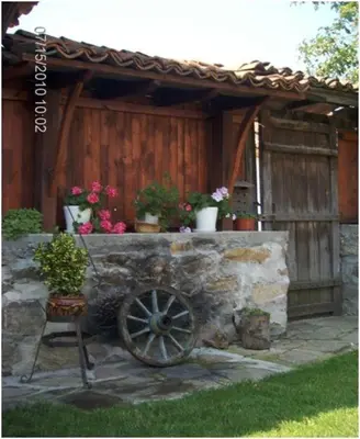 a stone wall with potted plants on top of it at Янко Кехая in Koprivshtitsa