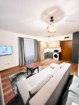 a living room with a couch and a table at Pirin Golf Hotel Private Studios - Sani, Bansko in Razlog