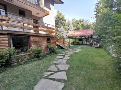 a backyard of a house with a stone path at Вила Край реката in Botevgrad