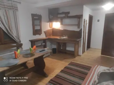 a living room with a table and a desk at Вила 111 in Sapareva Banya