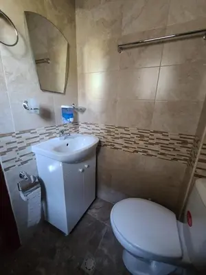 a bathroom with a toilet and a sink and a mirror at Вила 111 in Sapareva Banya